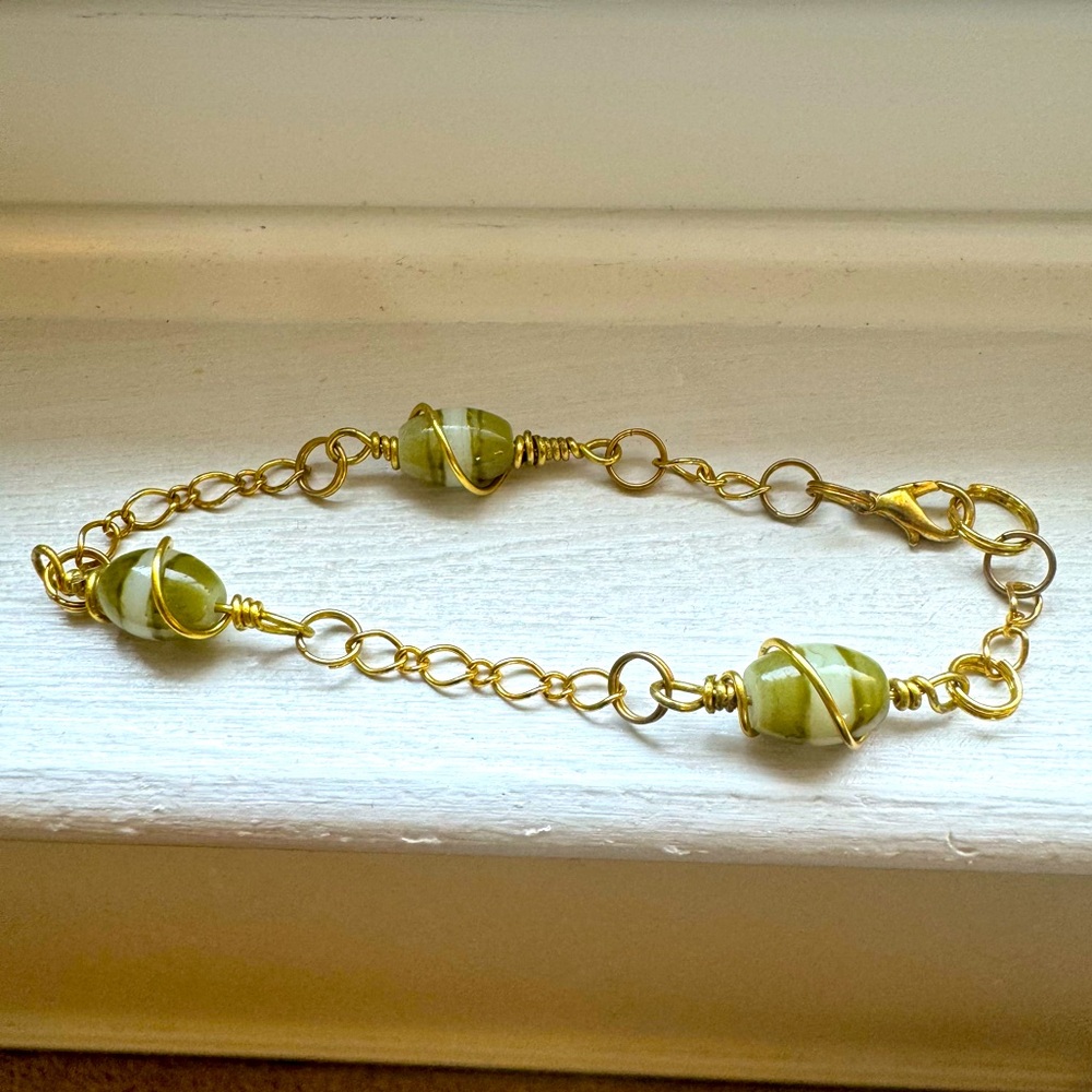 8" gold tone bracelet with green jade-tone beads. Never worn!